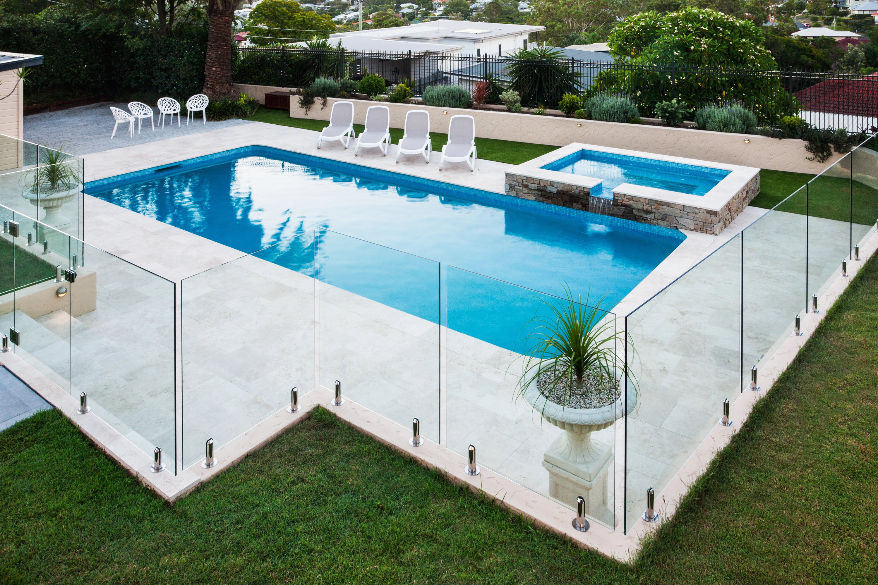 An image of a pool enclosed by glass panels outside